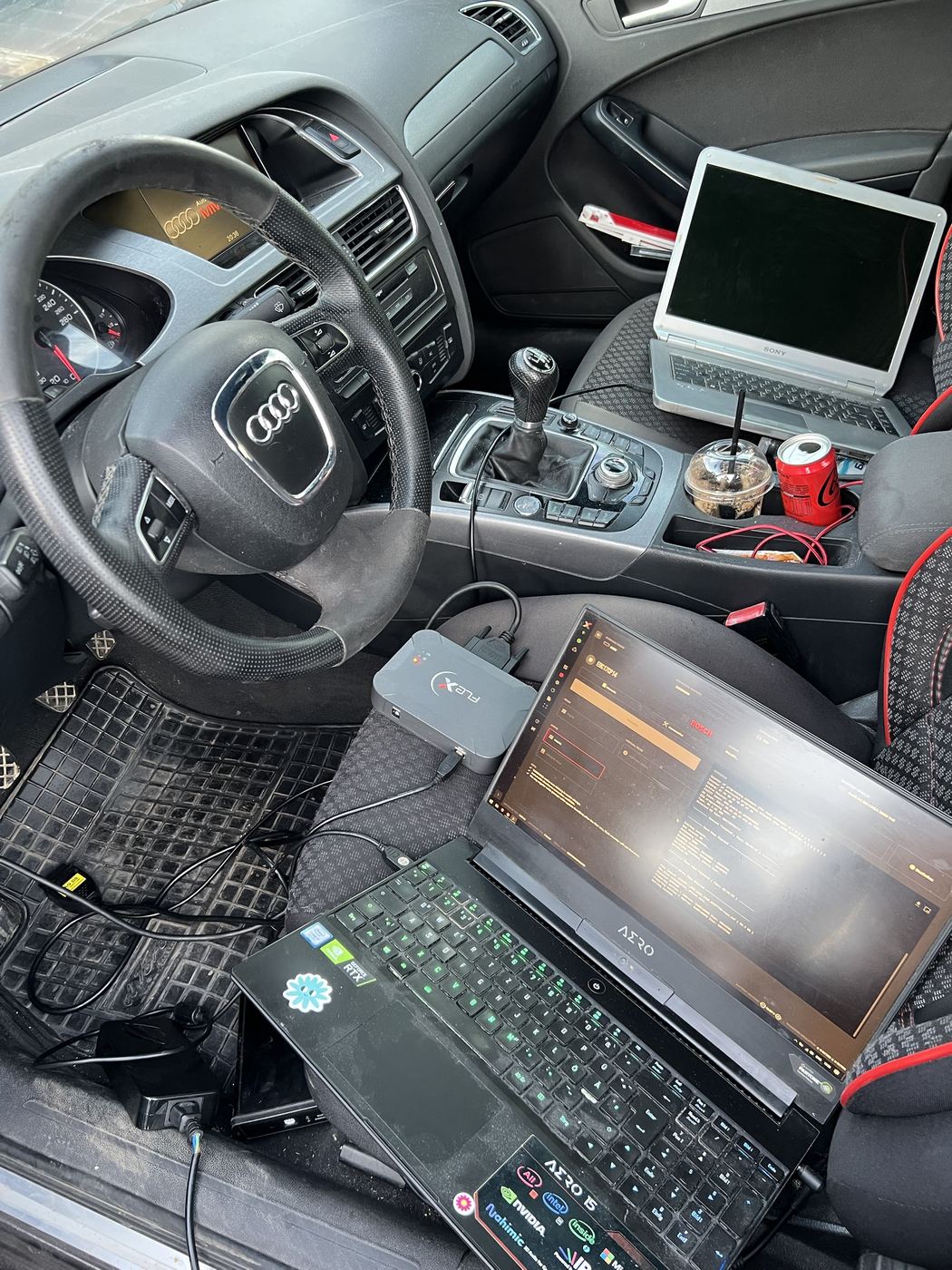 Audi A4 interior with Flex programmer and laptop flashing the ECU