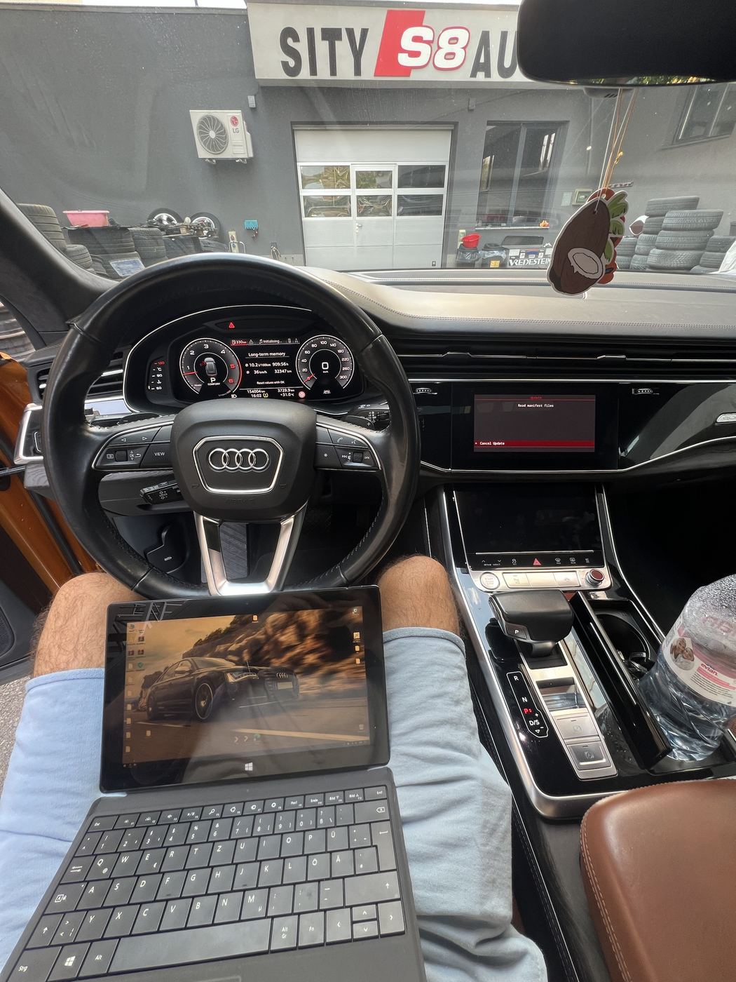 Audi Q8 cockpit during a software update with a tablet connected